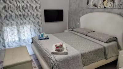 a bedroom with a bed with a tv on the wall at Casa Stella in Palermo