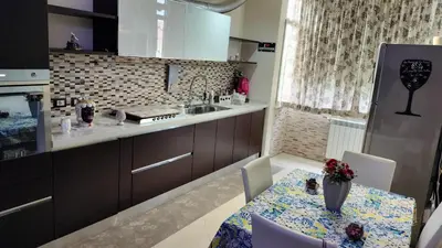 a kitchen with a table and a sink and a refrigerator at Casa Stella in Palermo