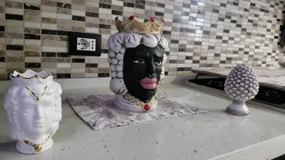 a statue of a head with a crown on a counter at Casa Stella in Palermo