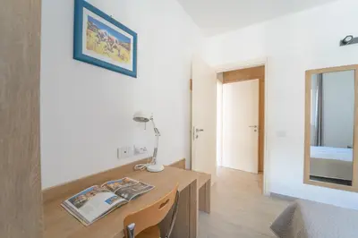 a room with a desk with a lamp and a mirror at Central Station Apartment 24 in Palermo
