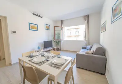 a living room with a table and a couch at Central Station Apartment 24 in Palermo