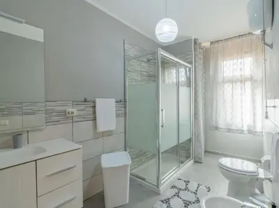 a bathroom with a glass shower and a toilet at Casa Vacanze La Dolce Vita in Mandra Capreria