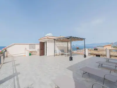a patio with benches and a pavilion on a roof at Casa Vacanze Ginevra in Mandra Capreria