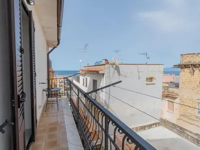 a balcony with a view of a building at Casa Vacanze Ginevra in Mandra Capreria