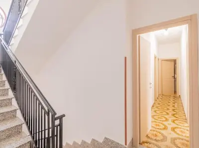 a hallway with stairs and a door leading into a room at Casa Vacanze Ginevra in Mandra Capreria