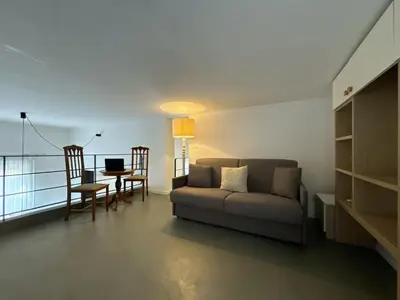 a living room with a couch and a table with a laptop at Laura's Apartment in Palermo