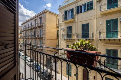 a balcony of a building with a plant on it at Azizò, la Gialla in Palermo