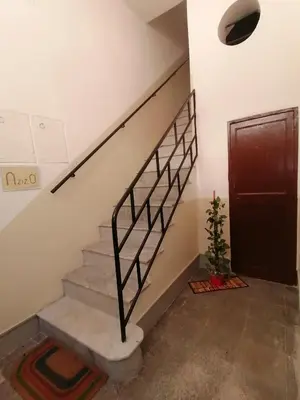 a staircase with a metal railing next to a door at Azizò, la Verde in Palermo