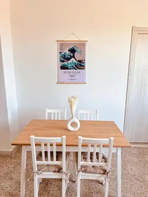 a bed on the beach with the sunset in the background at Sicily Apartment 4 - BLUE WAVES in Campofelice di Roccella