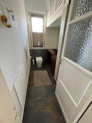 a bathroom with a toilet and a bathroom door at Appartamento vicino il centro in Palermo