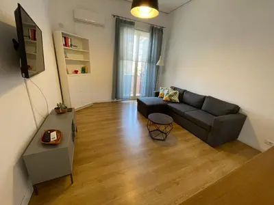 a living room with a couch and a table at Appartamento vicino il centro in Palermo