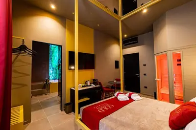 a room with a bed and a desk in it at GOLD Suite&SPA in Palermo