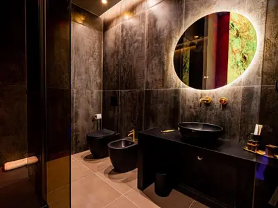 a bathroom with two toilets and a sink and a mirror at GOLD Suite&SPA in Palermo