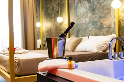 a bathroom with a sink and a bottle of wine at GOLD Suite&SPA in Palermo