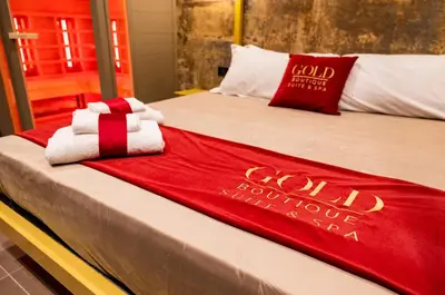 a bed with a red and white blanket on it at GOLD Suite&SPA in Palermo