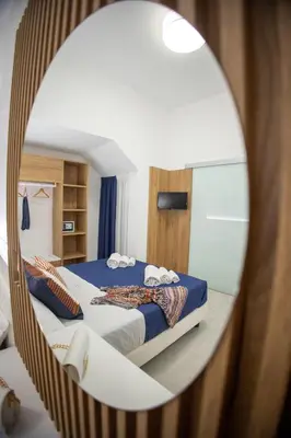 a bedroom with a bed and a mirror at Casa Grazia in Partinico