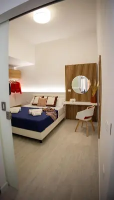 a bedroom with a bed and a mirror at Casa Grazia in Partinico