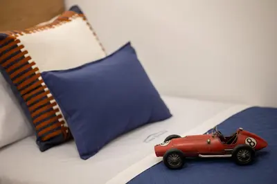 a toy car sitting on top of a bed at Casa Grazia in Partinico