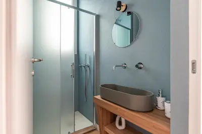 a bathroom with a sink and a glass shower at Casetta al Molo di Mondello by Wonderful Italy in Palermo