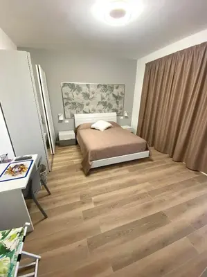 a bedroom with a bed and a wooden floor at Villa due Scale in Palermo