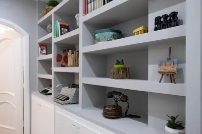 a room with white shelves with toys on them at Villa due Scale in Palermo
