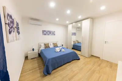 a bedroom with a blue bed in a room at I RE di SICILIA 2 in Palermo