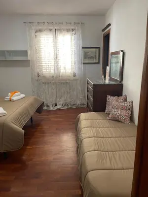 a living room with a couch and a window at Le Terrazze Élite Apartment in Palermo