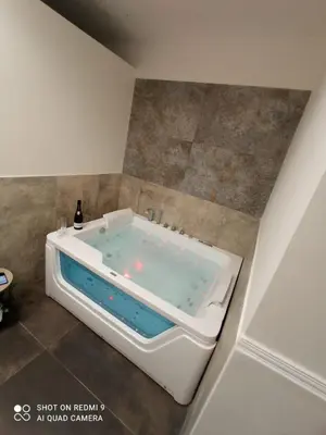 a bath tub sitting in a bathroom with at Aragona House in Palermo