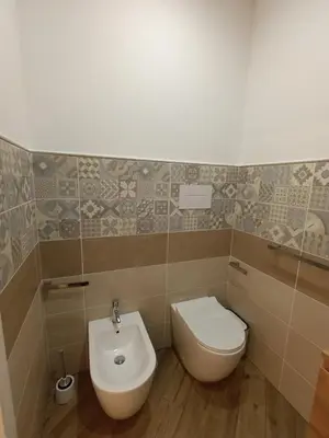 a bathroom with a toilet and a sink at Balarm Central Apartment in Palermo