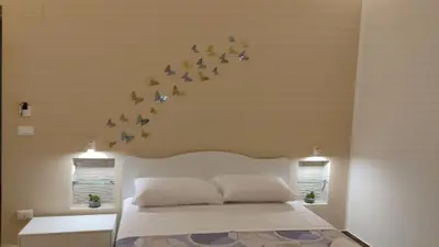 a bedroom with a bed with birds on the wall at Balarm Central Apartment in Palermo