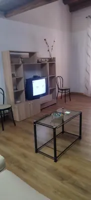 a living room with a coffee table and a tv at B&b da Ely in Ventimiglia di Sicilia