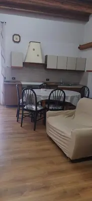 a living room with a table and chairs and a couch at B&b da Ely in Ventimiglia di Sicilia