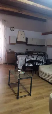a living room with a table and chairs and a couch at B&b da Ely in Ventimiglia di Sicilia