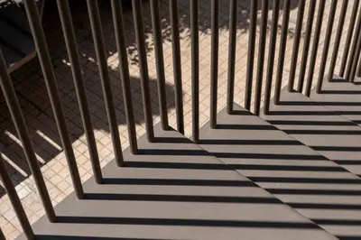 a shadow of a fence on a sidewalk at Cilea Apartments in Palermo