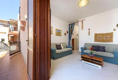 a living room with two couches and a table at I Tre Golfi - Pianeti in San Vito lo Capo