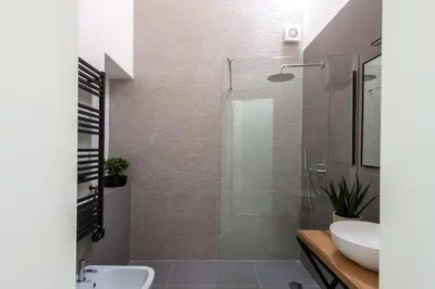 a bathroom with a glass shower and a sink at Kalsa miniLoft by Wonderful Italy in Palermo