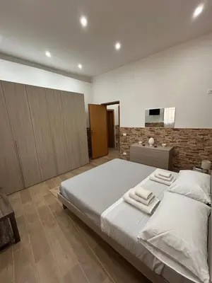 a bedroom with a large bed with towels on it at Home Love in Palermo