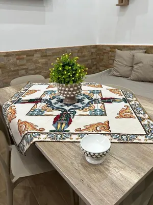 a table with a table cloth and a vase on it at Home Love in Palermo