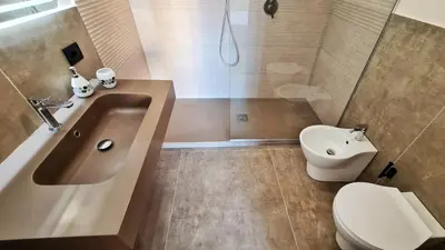 a bathroom with a sink and a toilet and a shower at The blue and red rooms in Bagheria