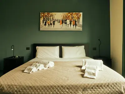a bedroom with a bed with two pillows on it at HUB Rooms in Carini