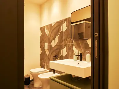 a bathroom with a sink and a toilet at HUB Rooms in Carini