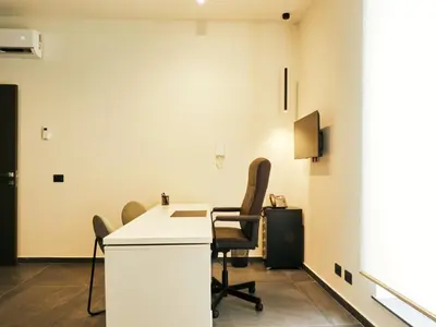 an office with a desk and chairs in a room at HUB Rooms in Carini