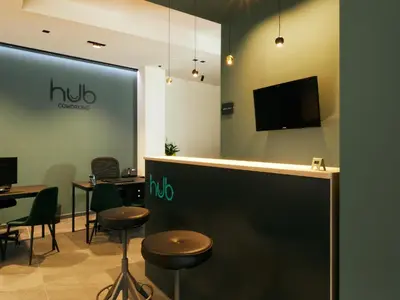 a restaurant with a bar with stools and a tv at HUB Rooms in Carini