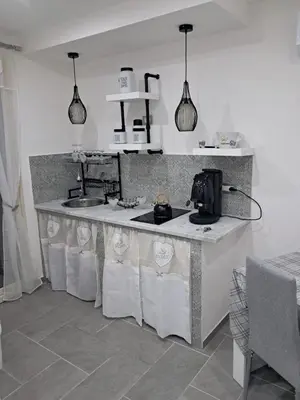 a kitchen with a counter with a sink and a stove at Pietro Fudduni Apartment in Palermo