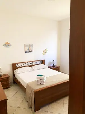 a bedroom with a bed with two towels on it at Sole di Sicilia in Castelluzzo