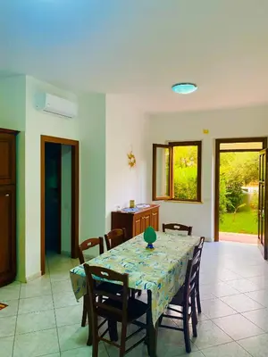 a dining room with a table and some chairs at Sole di Sicilia in Castelluzzo