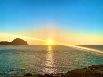 a sunset over the ocean with the sun in the sky at Sole di Sicilia in Castelluzzo
