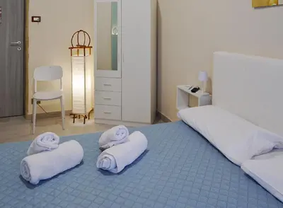 a bedroom with two white towels on a bed at Isola dei tesori - affittacamere palermo in Palermo