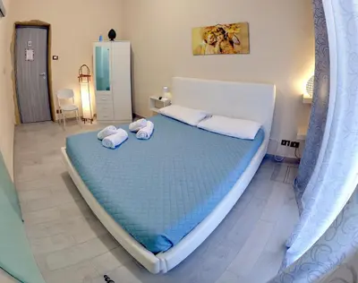 a bedroom with a large bed with towels on it at Isola dei tesori - affittacamere palermo in Palermo