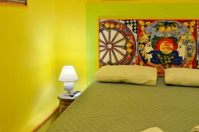 a bedroom with a bed with a dart board on the wall at Isola dei tesori - affittacamere palermo in Palermo